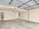 Spacious garage with concrete flooring, overhead lighting, and utility door at 1183 Woods Ne Cir, Atlanta, GA 30324