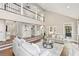 Open living room showcasing hardwood floors, a balcony, a fireplace, and comfortable seating at 1183 Woods Ne Cir, Atlanta, GA 30324