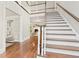 Elegant staircase showcasing wood treads, white risers, and views into a living room with a fireplace at 1183 Woods Ne Cir, Atlanta, GA 30324