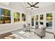 Bright sunroom with large windows overlooking the private backyard and leading to a wood deck at 1183 Woods Ne Cir, Atlanta, GA 30324
