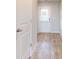 Well-lit hallway with hardwood floors and a view of the exterior door at 160 Weldon Rd, Mcdonough, GA 30253