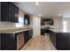 Modern kitchen featuring stainless steel appliances, dark cabinets and granite countertops at 160 Weldon Rd, Mcdonough, GA 30253