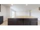 Kitchen island boasts granite countertop and dark brown cabinetry at 160 Weldon Rd, Mcdonough, GA 30253