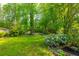 Serene backyard featuring lush greenery, a well-manicured lawn, and privacy fence at 2810 Stillwater Park Dr, Marietta, GA 30066