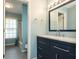 Bathroom view with navy vanity, granite countertops, and tile flooring adjacent to a shower-tub combination at 2810 Stillwater Park Dr, Marietta, GA 30066