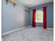 This cozy bedroom features plush carpeting, an arched window with red curtains and floating shelves at 2810 Stillwater Park Dr, Marietta, GA 30066