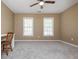This bedroom has carpet flooring, a ceiling fan, and is brightly lit with two windows at 2810 Stillwater Park Dr, Marietta, GA 30066