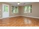 This living room features hardwood floors, large windows, and a ceiling fan at 2810 Stillwater Park Dr, Marietta, GA 30066