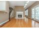 Cozy living room features a fireplace, hardwood floors, and seamless connection to the kitchen and staircase at 2810 Stillwater Park Dr, Marietta, GA 30066