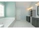 Beautiful bathroom with double vanity sinks, white tile flooring, and a soaking tub with a window at 2810 Stillwater Park Dr, Marietta, GA 30066