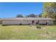 The back exterior of the house with manicured lawn, landscaping and concrete patio at 3998 Wabash Ln, Ellenwood, GA 30294