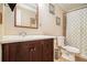 Traditional bathroom featuring dark vanity with sink, toilet, and tiled shower/tub at 3998 Wabash Ln, Ellenwood, GA 30294