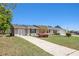 Inviting home showcasing a well-maintained lawn, ample parking, and colorful landscaping at 3998 Wabash Ln, Ellenwood, GA 30294