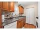 Well-lit kitchen featuring granite countertops, wood cabinets, and modern appliances at 3998 Wabash Ln, Ellenwood, GA 30294