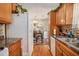Functional kitchen featuring wood cabinets, appliances, and a view into the adjacent dining area at 3998 Wabash Ln, Ellenwood, GA 30294