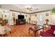 Spacious living room with hardwood floors, a fireplace, and ample seating at 3998 Wabash Ln, Ellenwood, GA 30294
