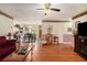 Open-concept living room flowing into the dining area with hardwood floors and bright lighting at 3998 Wabash Ln, Ellenwood, GA 30294