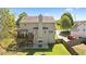 The back of the house features a deck, a patio, and a fenced yard with trees and a well maintained lawn at 826 Buffington Way, Canton, GA 30115