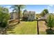 Well-manicured backyard showcasing a spacious lawn and two-story home with wooden deck at 826 Buffington Way, Canton, GA 30115