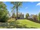 Expansive, green backyard featuring a well-maintained lawn and a two-story home with a deck at 826 Buffington Way, Canton, GA 30115