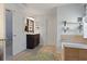 Bathroom features a vanity with storage and a decorative rug on the tile floor at 826 Buffington Way, Canton, GA 30115