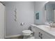Bathroom includes white cabinets, commode, and a vanity at 826 Buffington Way, Canton, GA 30115
