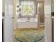 Ensuite bathroom with soaking tub, separate shower, and decorative window at 826 Buffington Way, Canton, GA 30115