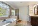 This bathroom boasts a glass enclosed shower, garden tub, and a neutral tile floor at 826 Buffington Way, Canton, GA 30115