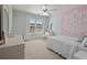 Light and airy bedroom with bright walls, a ceiling fan and large window at 826 Buffington Way, Canton, GA 30115