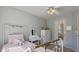 Bright bedroom featuring a metal bedframe, white ceiling fan, and plush carpet at 826 Buffington Way, Canton, GA 30115