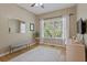 Light-filled bedroom features hardwood floors, a neutral color palette, and a large window at 826 Buffington Way, Canton, GA 30115