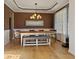 Dining room with hardwood flooring, elegant lighting, and neutral paint, creating a welcoming atmosphere at 826 Buffington Way, Canton, GA 30115