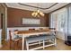 Bright dining room with hardwood flooring, elegant chandelier, and large window, creating a welcoming atmosphere at 826 Buffington Way, Canton, GA 30115
