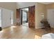 Bright foyer with white trim, hardwood floors and rustic barn door to living space at 826 Buffington Way, Canton, GA 30115