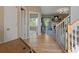 Foyer and entry to staircase and living area with hardwood floors and white trim at 826 Buffington Way, Canton, GA 30115