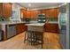 Spacious kitchen with stainless steel appliances, hardwood floors, and a center island with seating at 826 Buffington Way, Canton, GA 30115