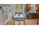 Bright kitchen with hardwood floors and wood cabinets features a breakfast nook and view to the living room at 826 Buffington Way, Canton, GA 30115