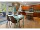 Well-lit kitchen features wood cabinets, an island with breakfast bar, and a breakfast table near the back door at 826 Buffington Way, Canton, GA 30115