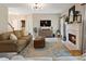 Open-concept living room with fireplace, hardwood floors, and natural light at 826 Buffington Way, Canton, GA 30115