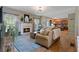Cozy living room with hardwood floors, fireplace, and view of open kitchen at 826 Buffington Way, Canton, GA 30115