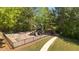 Neighborhood playground with swings, slides, and climbing structures surrounded by lush trees at 826 Buffington Way, Canton, GA 30115