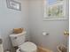 Cozy half bathroom featuring a toilet, small window and minimal design at 826 Buffington Way, Canton, GA 30115
