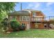 Back exterior elevation with a small deck and a lush green backyard at 1740 Manhasset Pl, Atlanta, GA 30338