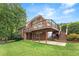 Backyard with a deck, patio area, green grass, and some bushes at 1740 Manhasset Pl, Atlanta, GA 30338