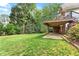 Green backyard featuring a deck with railings and a stone patio area at 1740 Manhasset Pl, Atlanta, GA 30338