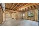 Unfinished basement with concrete floors, exposed wood beams, and an exterior door at 1740 Manhasset Pl, Atlanta, GA 30338