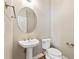 Charming half bathroom featuring pedestal sink, toilet and fixtures at 1740 Manhasset Pl, Atlanta, GA 30338