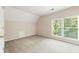 Neutral bedroom features a large window, light colored carpet and a closet at 1740 Manhasset Pl, Atlanta, GA 30338