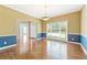 Dining room with hardwood floors, large window, and a stylish two-tone wall design at 1740 Manhasset Pl, Atlanta, GA 30338