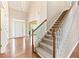 Elegant foyer with hardwood floors, chandelier, staircase, and decorative glass above the front door at 1740 Manhasset Pl, Atlanta, GA 30338